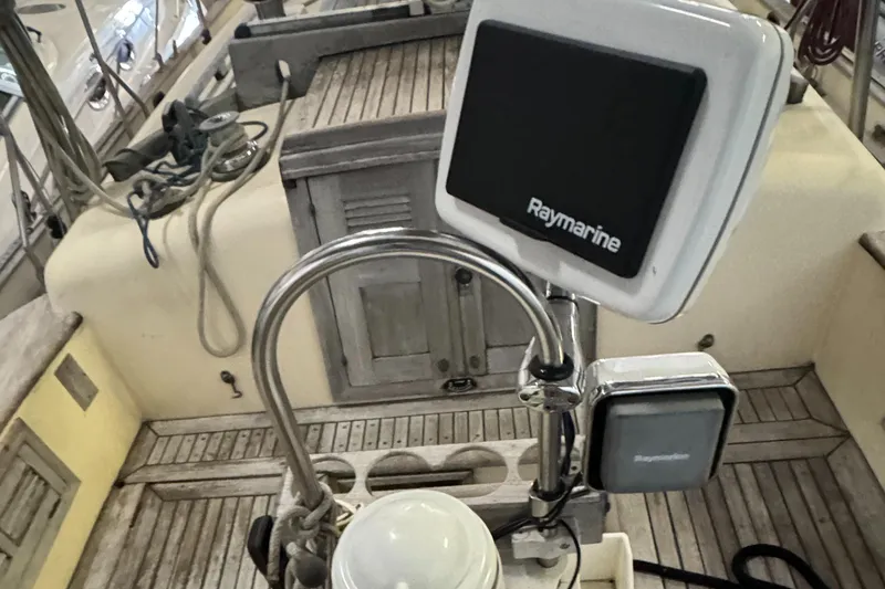 Slide: The Image of 1984 Young Sun 35 sailboat cockpit with wooden deck and steering wheel. - 4