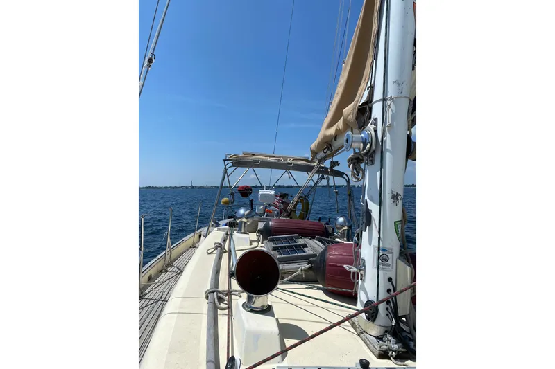 Slide: The Image of Sailing yacht Young Sun 35, 1984 model, cruising on open water under clear blue skies. - 6