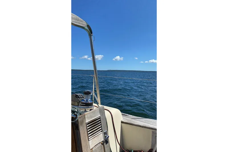Slide: The Image of Sailing on a 1984 Young Sun 35 boat under clear blue skies. - 7