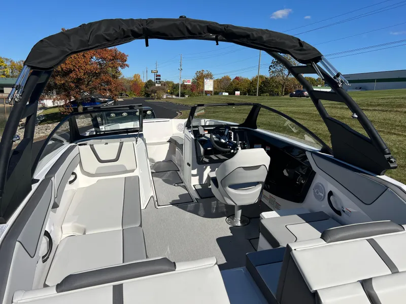 Slide: The Image of 2025 Yamaha Boats AR220 interior with sleek seating and modern dashboard. - 10