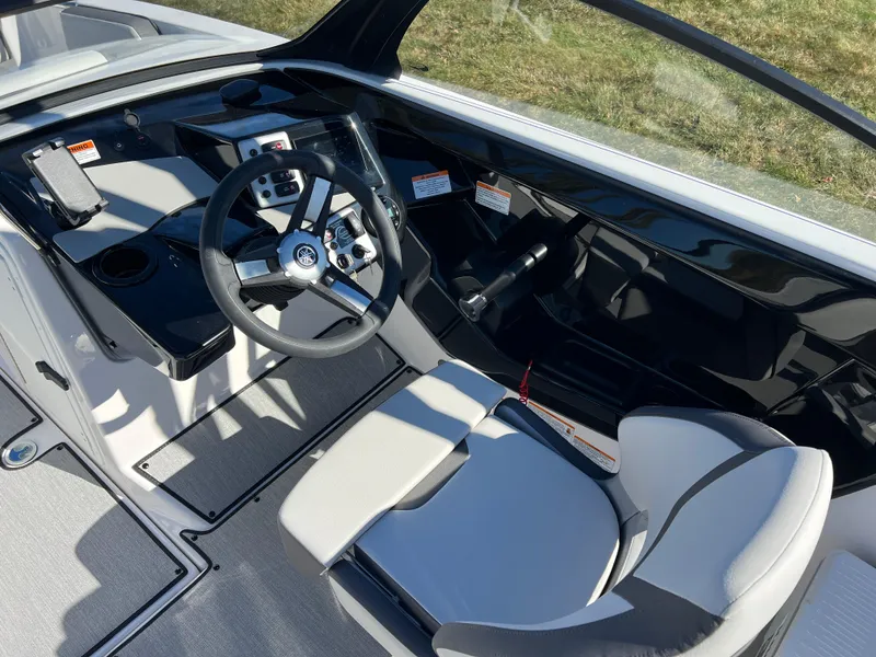 Slide: The Image of 2025 Yamaha Boats AR220 cockpit with sleek steering wheel and modern dashboard design. - 14