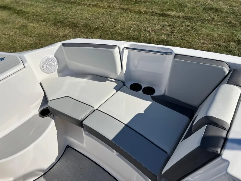 Slide: The Image of 2025 Yamaha AR220 boat interior with cushioned seating and cup holders. - 17
