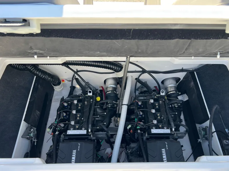 Slide: The Image of 2025 Yamaha AR220 boat engine compartment with dual engines and wiring. - 24