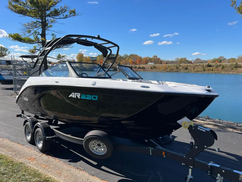Slide: The Image of 2025 Yamaha Boats AR220 on trailer by a scenic lake. - 3