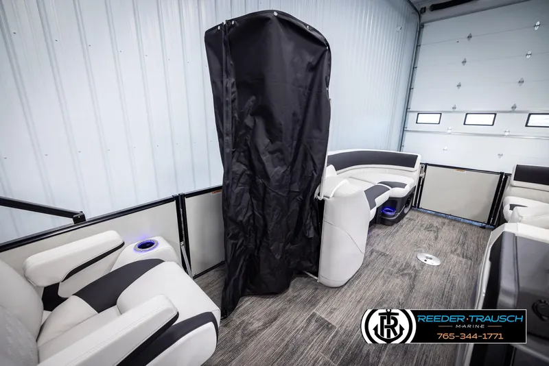 Slide: The Image of 2025 Avalon Catalina QL interior with modern seating and privacy curtain in a showroom. - 22