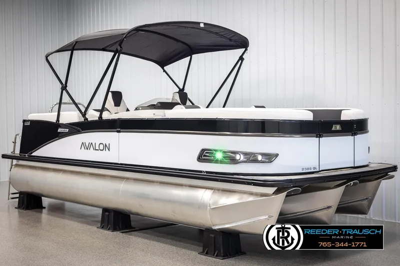 Slide: The Image of 2025 Avalon Catalina QL pontoon boat with canopy, displayed indoors. - 3