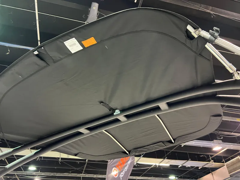 Slide: The Image of 2025 Yamaha Boats AR195 bimini top, black fabric, indoor display. - 10