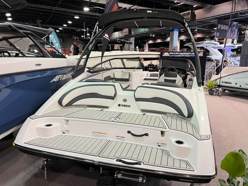 Slide: The Image of 2025 Yamaha AR195 boat displayed at an indoor boat show. - 2