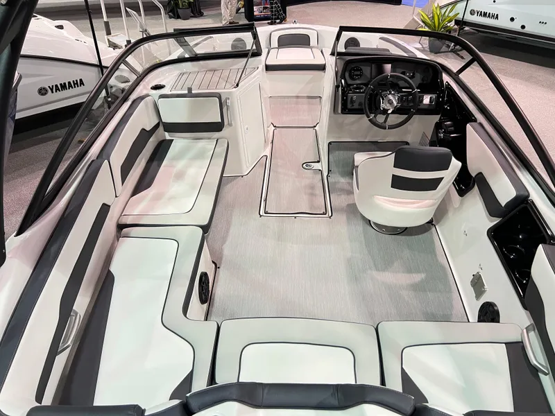 Slide: The Image of 2025 Yamaha AR195 boat interior with modern seating and steering console. - 3