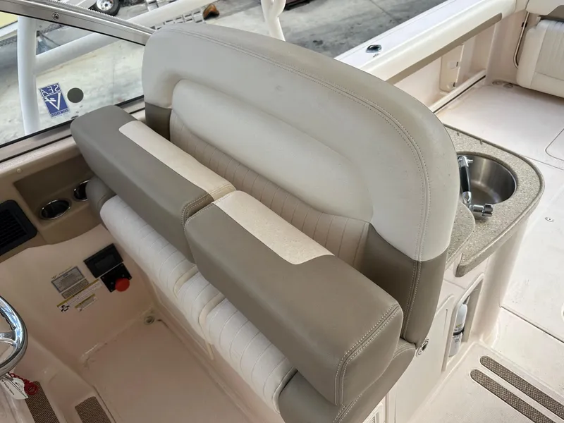 Slide: The Image of 2014 Grady-White Freedom 335 boat interior with beige seating and sink. - 18