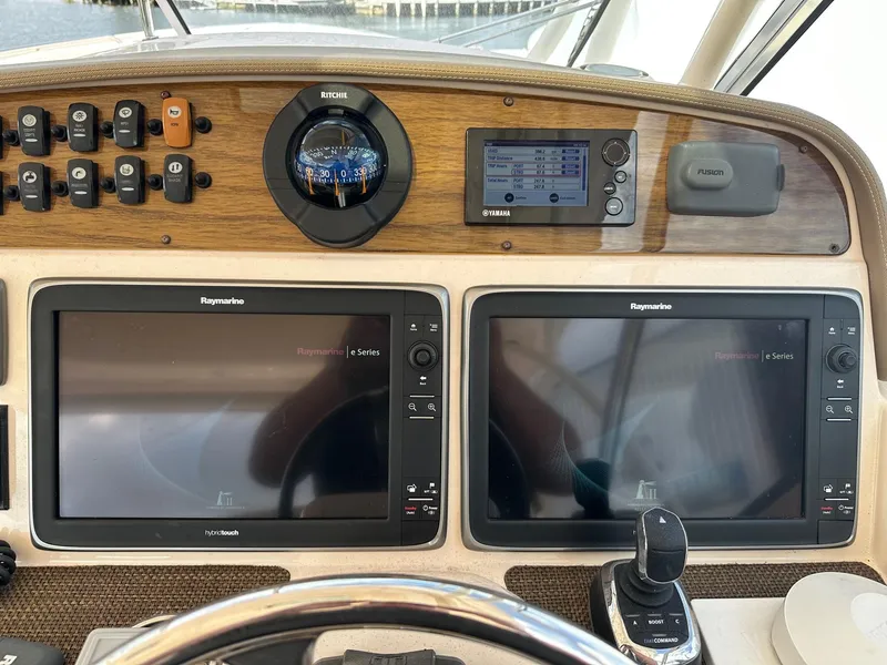 Slide: The Image of Grady-White Freedom 335 2014 dashboard with dual Raymarine displays and navigation controls. - 24