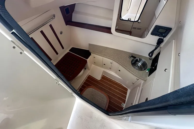Slide: The Image of 2014 Grady-White Freedom 335 cabin interior with sink and seating area. - 30