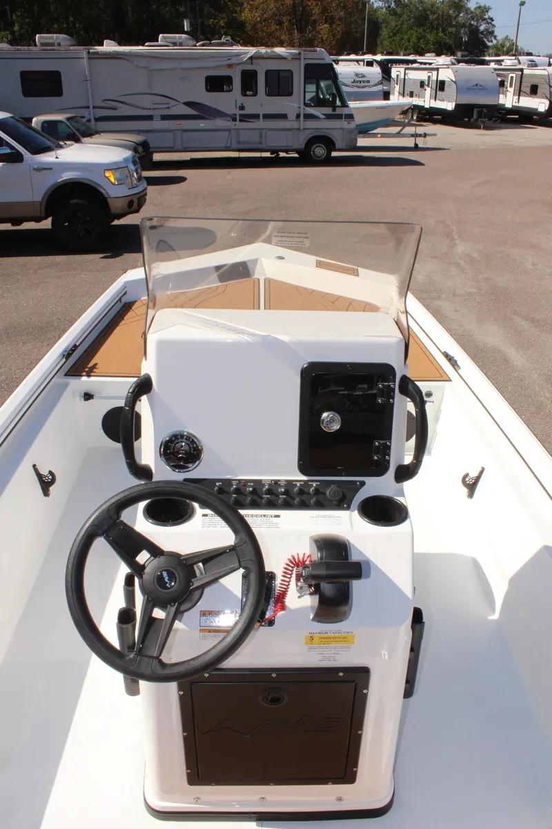 Slide: The Image of 2025 Avid 18 Rogue CC boat console with steering wheel and controls. - 10
