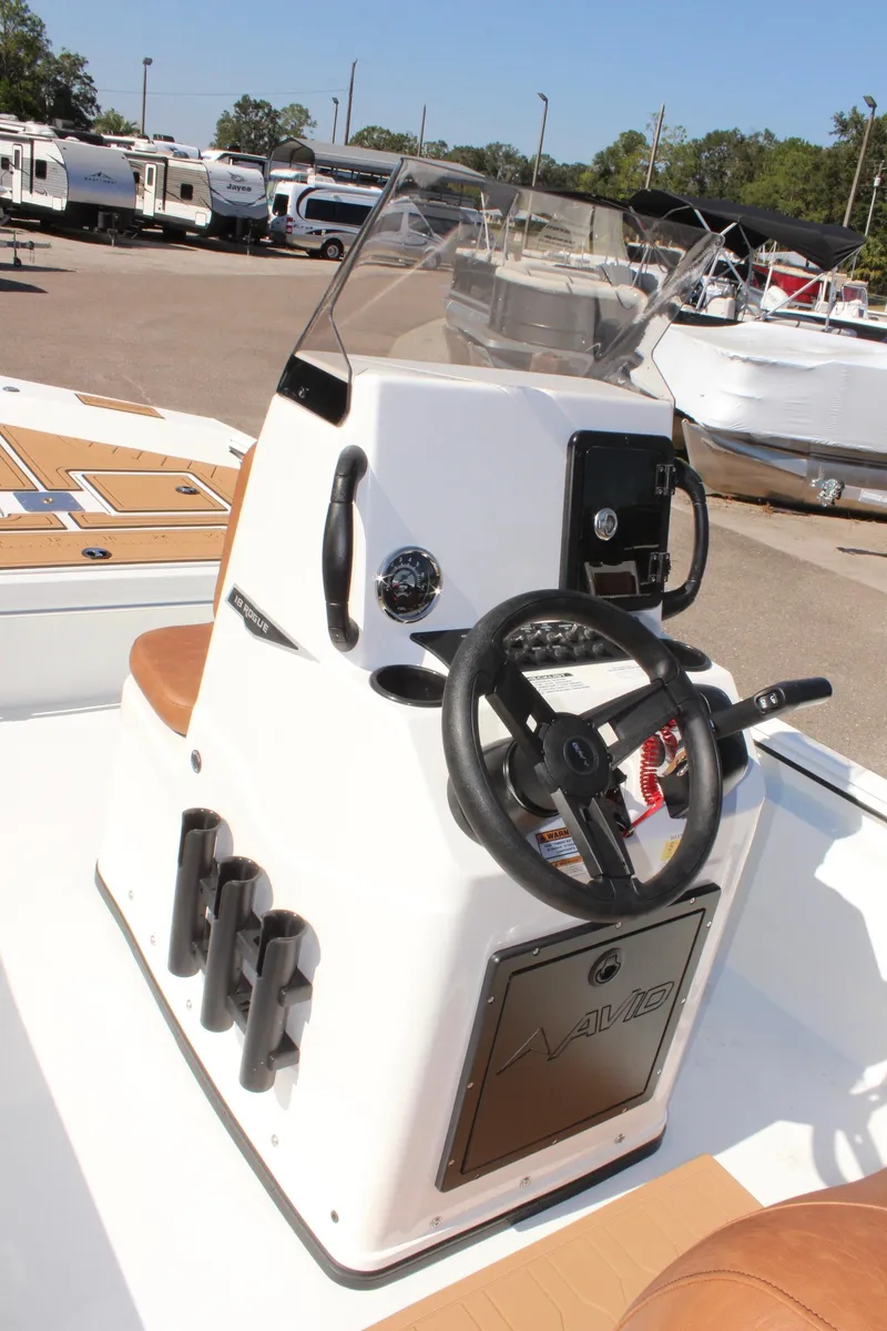 Slide: The Image of 2025 Avid 18 Rogue CC boat console with steering wheel and controls. - 11