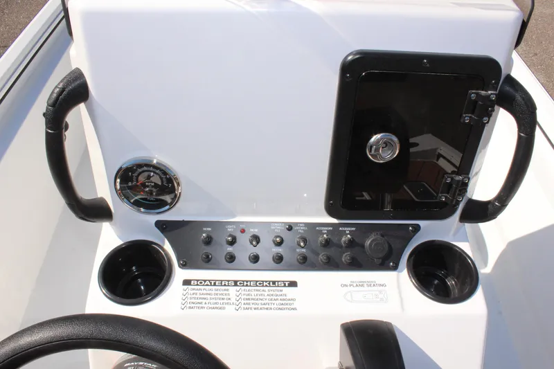 Slide: The Image of Avid 18 Rogue CC 2025 boat console with controls, gauges, and storage compartment. - 13