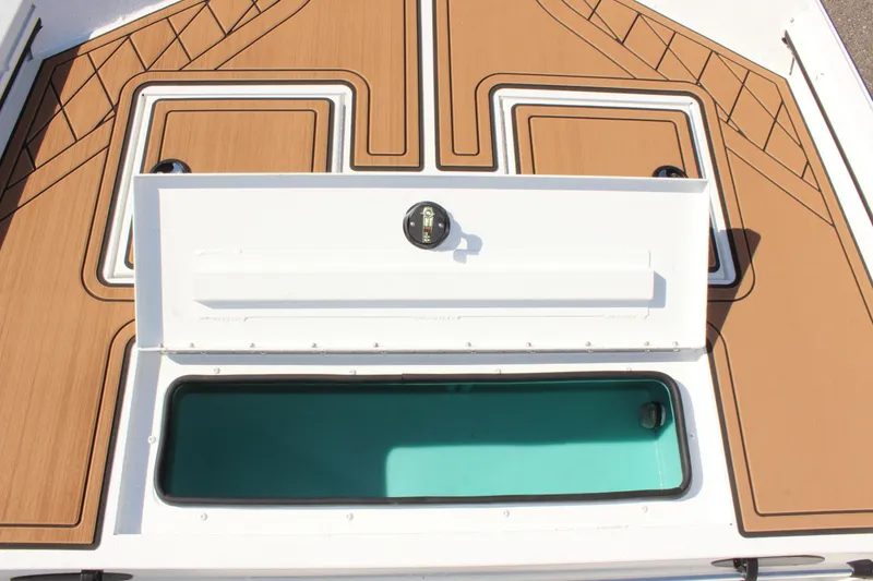 Slide: The Image of 2025 Avid 18 Rogue CC boat deck with open storage compartment. - 16