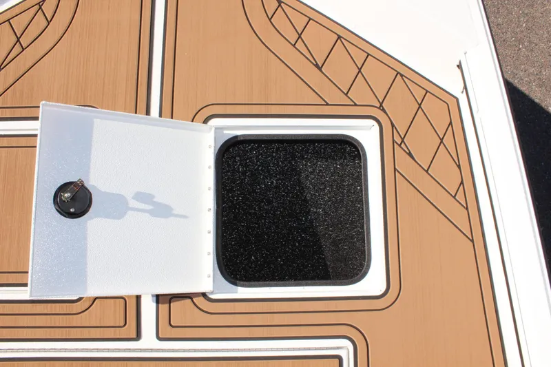 Slide: The Image of Avid 18 Rogue CC 2025 boat deck with open storage hatch. - 17