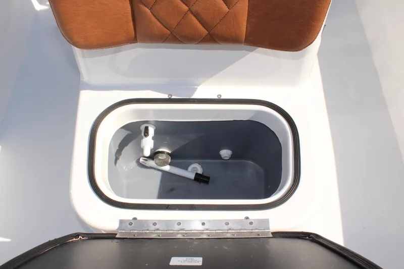 Slide: The Image of Livewell compartment in 2025 Avid 18 Rogue CC boat with cushioned seating. - 20