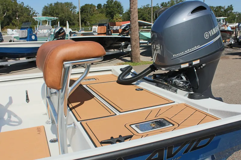 Slide: The Image of 2025 Avid 18 Rogue CC boat with Yamaha motor, featuring tan seating and deck. - 8