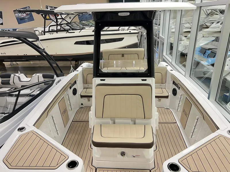 Slide: The Image of 2025 Yamaha Boats 222 FSH Sport E interior with beige seating and sleek design. - 10