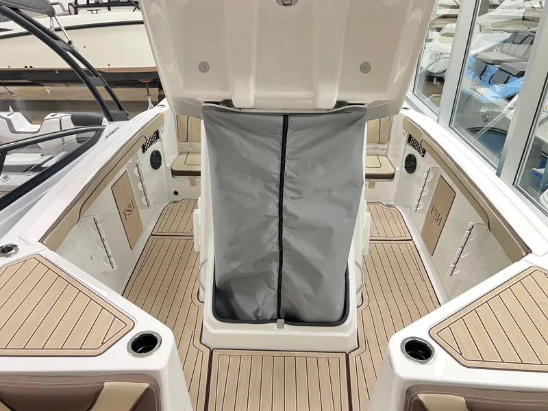 Slide: The Image of 2025 Yamaha Boats 222 FSH Sport E interior with open storage compartment. - 11