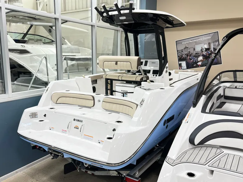 Slide: The Image of 2025 Yamaha Boats 222 FSH Sport E in showroom, rear view. - 2