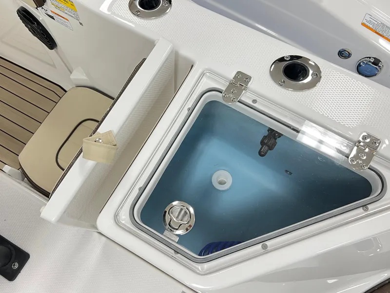 Slide: The Image of 2025 Yamaha Boats 222 FSH Sport E interior with livewell and seating area. - 5