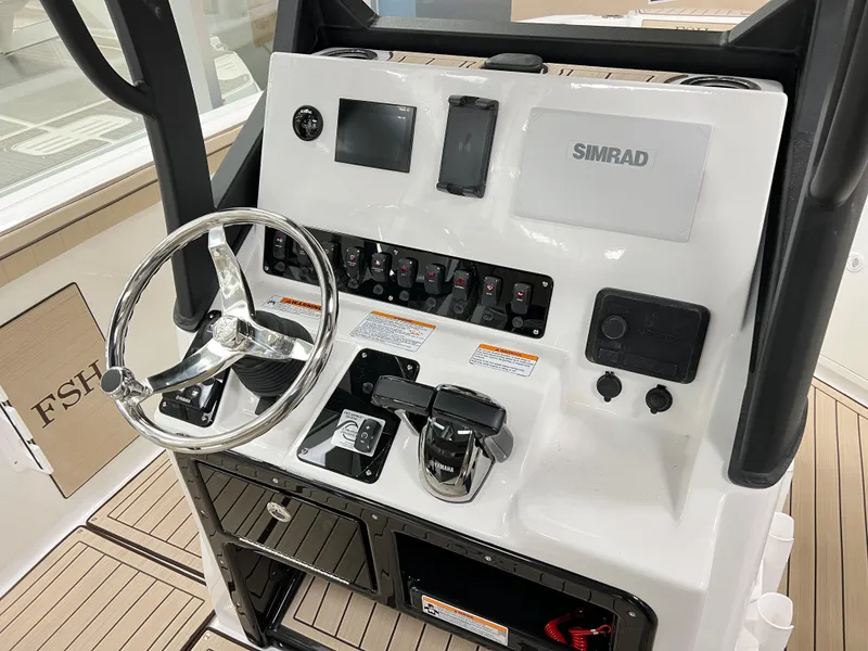 Slide: The Image of Control panel of 2025 Yamaha Boats 222 FSH Sport E with steering wheel and Simrad display. - 6