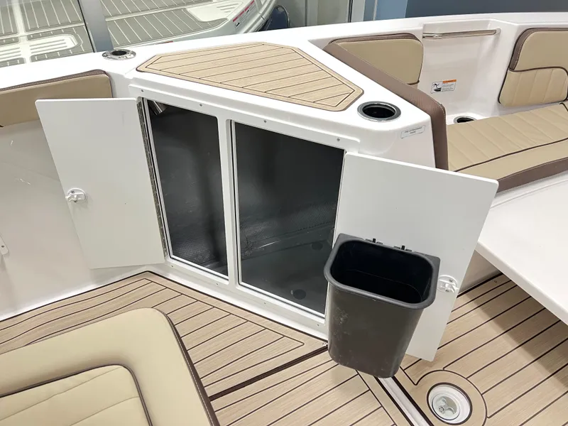 Slide: The Image of 2025 Yamaha Boats 222 FSH Sport E interior with storage compartment and seating. - 9