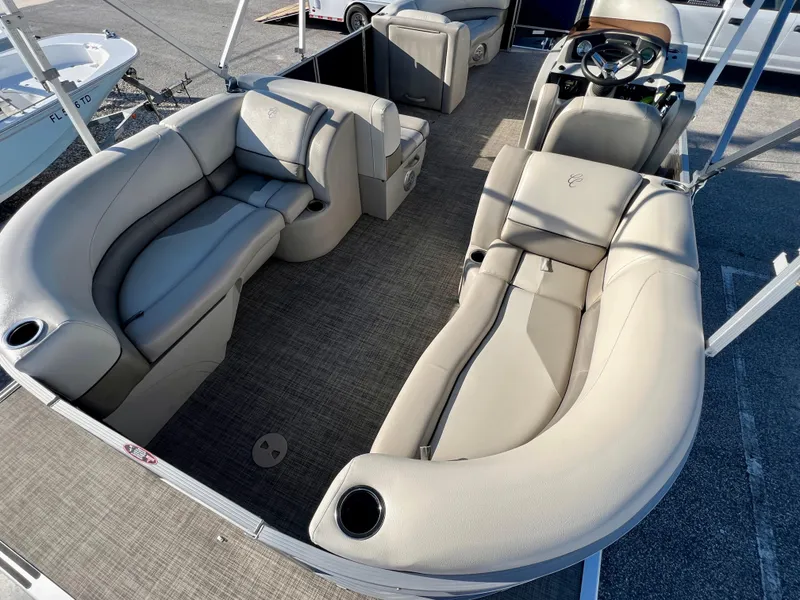 Slide: The Image of 2023 Cypress Cay Seabreeze 232 pontoon boat interior with plush seating and steering console. - 10
