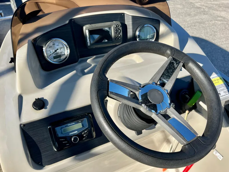 Slide: The Image of 2023 Cypress Cay Seabreeze 232 dashboard with steering wheel and gauges. - 12