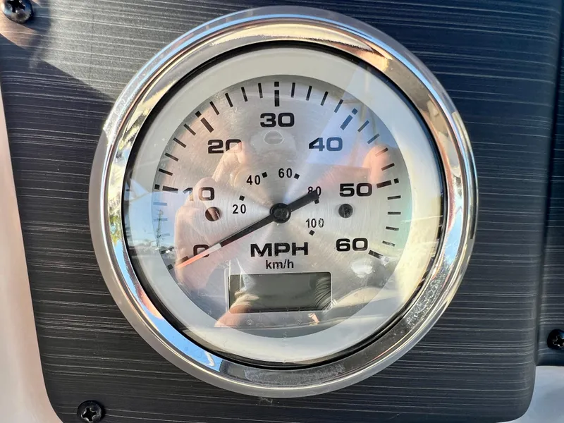 Slide: The Image of Close-up of a speedometer on a 2023 Cypress Cay Seabreeze 232 boat. - 13