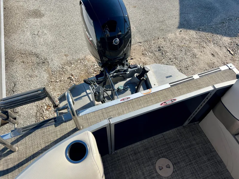 Slide: The Image of 2023 Cypress Cay Seabreeze 232 boat with Mercury outboard motor, rear deck view. - 19