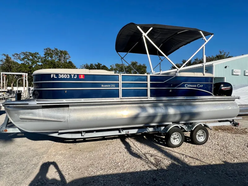 Slide: The Image of 2023 Cypress Cay Seabreeze 232 pontoon boat on trailer, sunny day. - 4