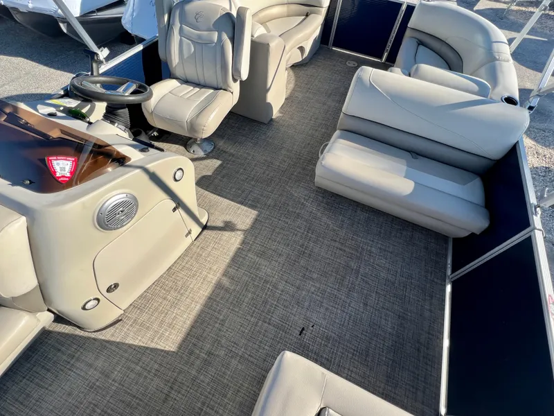 Slide: The Image of 2023 Cypress Cay Seabreeze 232 pontoon boat interior with beige seating and steering console. - 9