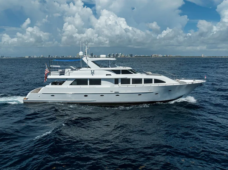 The Image of 1998 Westport Westbay Sonship Raised Pilothouse yacht cruising on open sea under cloudy sky. - 1