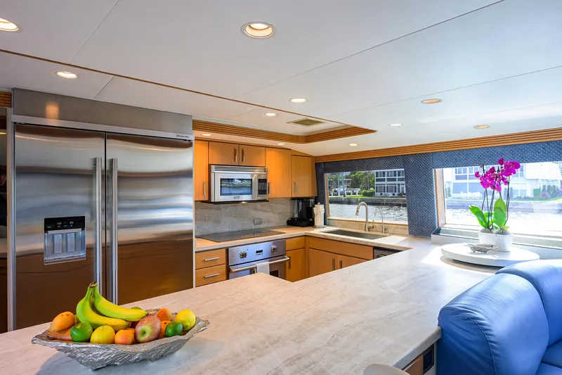 Slide: The Image of Luxurious yacht kitchen with modern appliances, fruit bowl, and vibrant orchid, Westport Westbay Sonship 1998. - 11