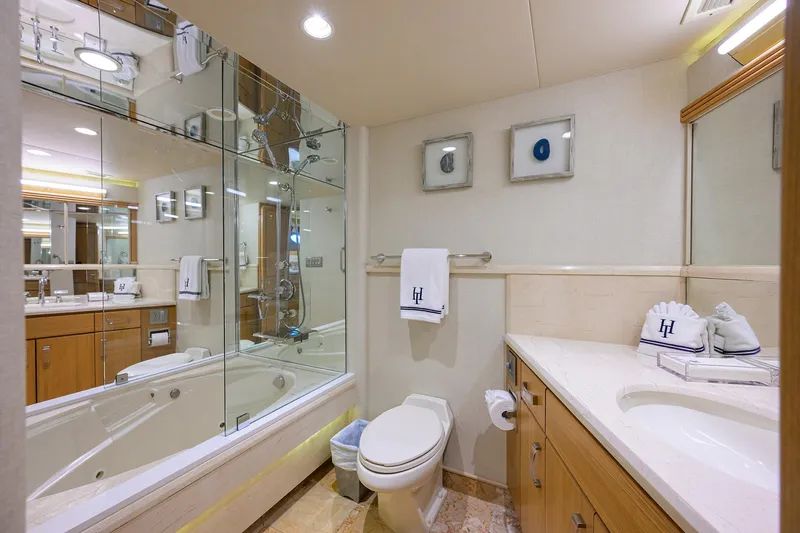 Slide: The Image of Luxurious yacht bathroom with modern fixtures, glass shower, and elegant decor in 1998 Westport Westbay Sonship. - 22