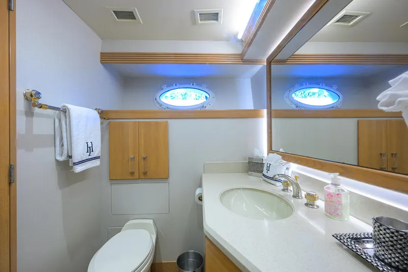 Slide: The Image of Luxurious yacht bathroom with modern fixtures, large mirror, and porthole window on Westport Westbay Sonship. - 30