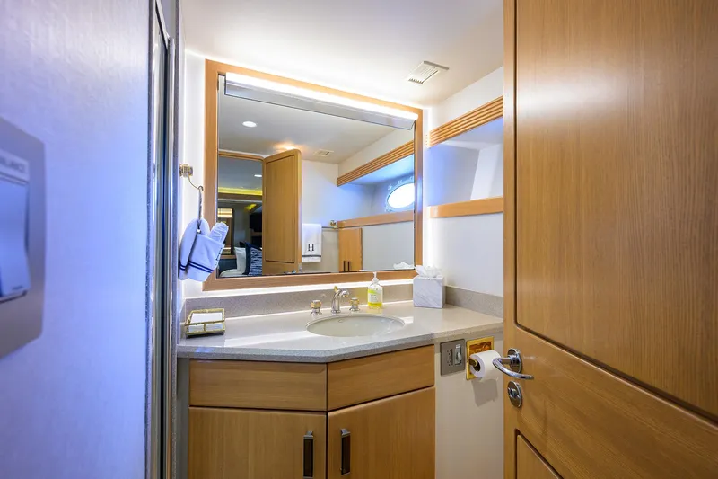 Slide: The Image of Luxurious bathroom in 1998 Westport Westbay Sonship Raised Pilothouse yacht, featuring wood cabinetry and modern fixtures. - 33