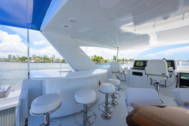 Slide: The Image of Luxurious 1998 Westport Westbay Sonship yacht deck with bar stools and scenic water view. - 39