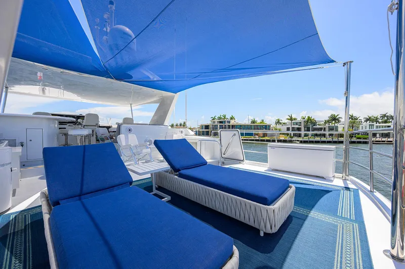 Slide: The Image of Luxurious 1998 Westport Westbay Sonship yacht deck with blue loungers and canopy. - 47