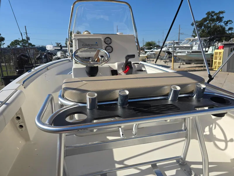 Slide: The Image of 2012 Key West 189 FS boat interior with steering console and rod holders. - 16