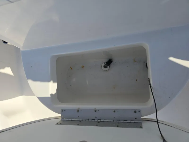Slide: The Image of Key West 189 FS 2012 boat storage compartment with open lid and visible hinge. - 19