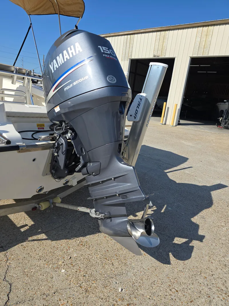 Slide: The Image of 2012 Key West 189 FS boat with Yamaha 150 outboard motor in a sunny marina. - 22