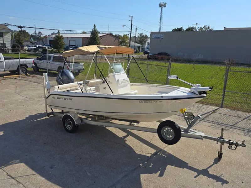 Slide: The Image of 2012 Key West 189 FS boat on trailer with canopy in parking lot. - 3