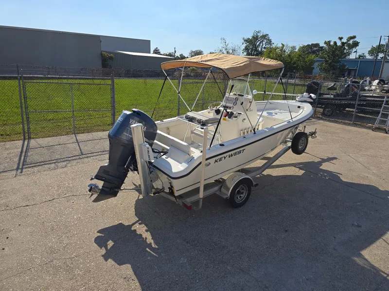 Slide: The Image of 2012 Key West 189 FS boat on trailer with canopy and outboard motor. - 9