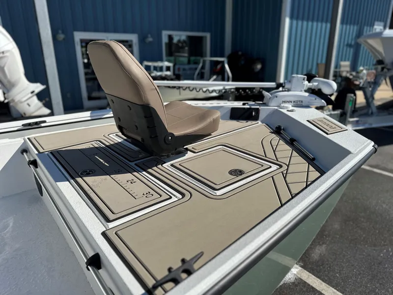 Slide: The Image of Avid 18 Rogue 2025 boat deck with seating and equipment, docked outdoors. - 1