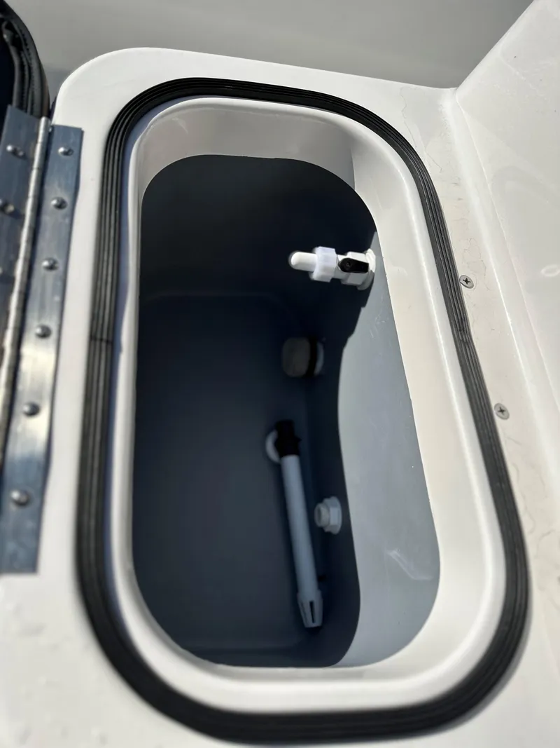 Slide: The Image of Avid 18 Rogue 2025 boat livewell with water inlet and drain. - 13