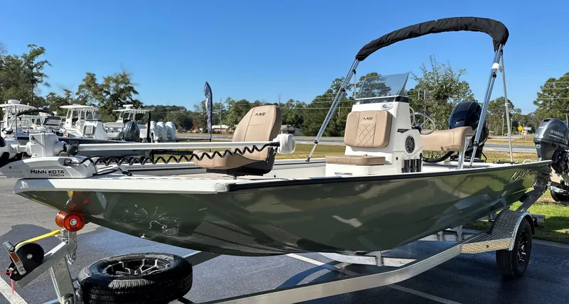 Slide: The Image of 2025 Avid 18 Rogue boat on trailer, parked outdoors, side view. - 18
